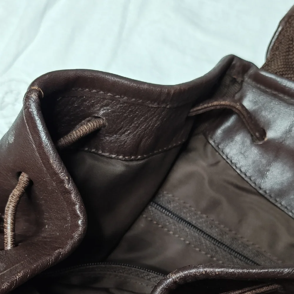 Tumi Italian Leather Drawstring Backpack Sling